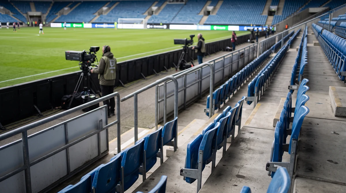 Football stadium with pitchside advertising boards prepared for an international broadcast.