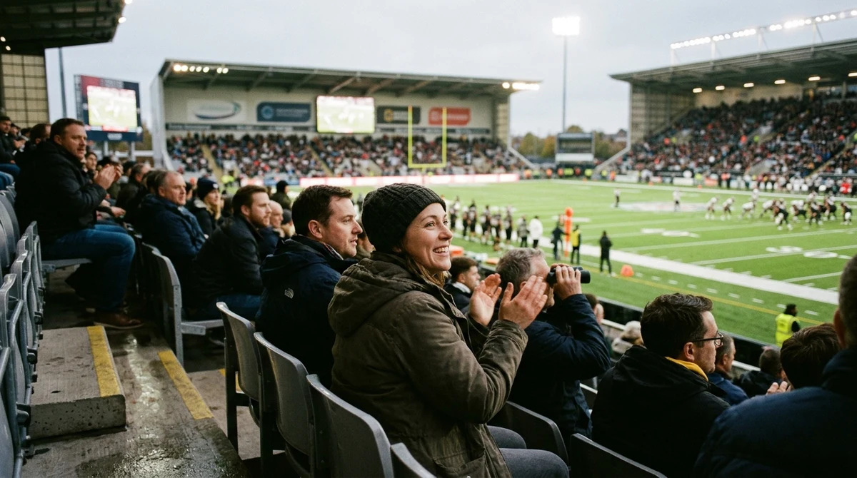 Adult fans watch an American football game in a UK stadium as a sports betting partnership receives national attention.