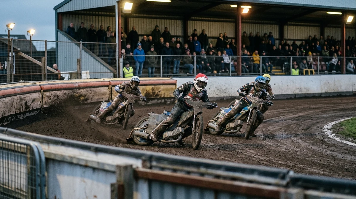Adult speedway riders race through a wet bend as supporters watch from an outdoor stadium.