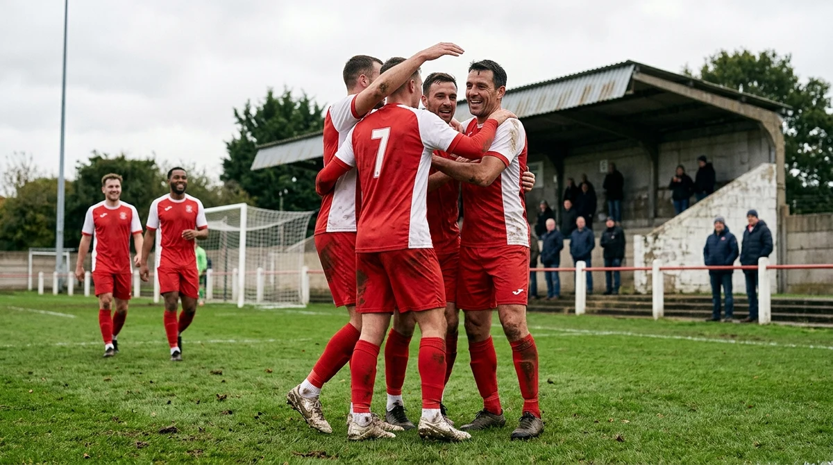 Illustrative scene of adult non-league footballers celebrating together on a modest pitch.